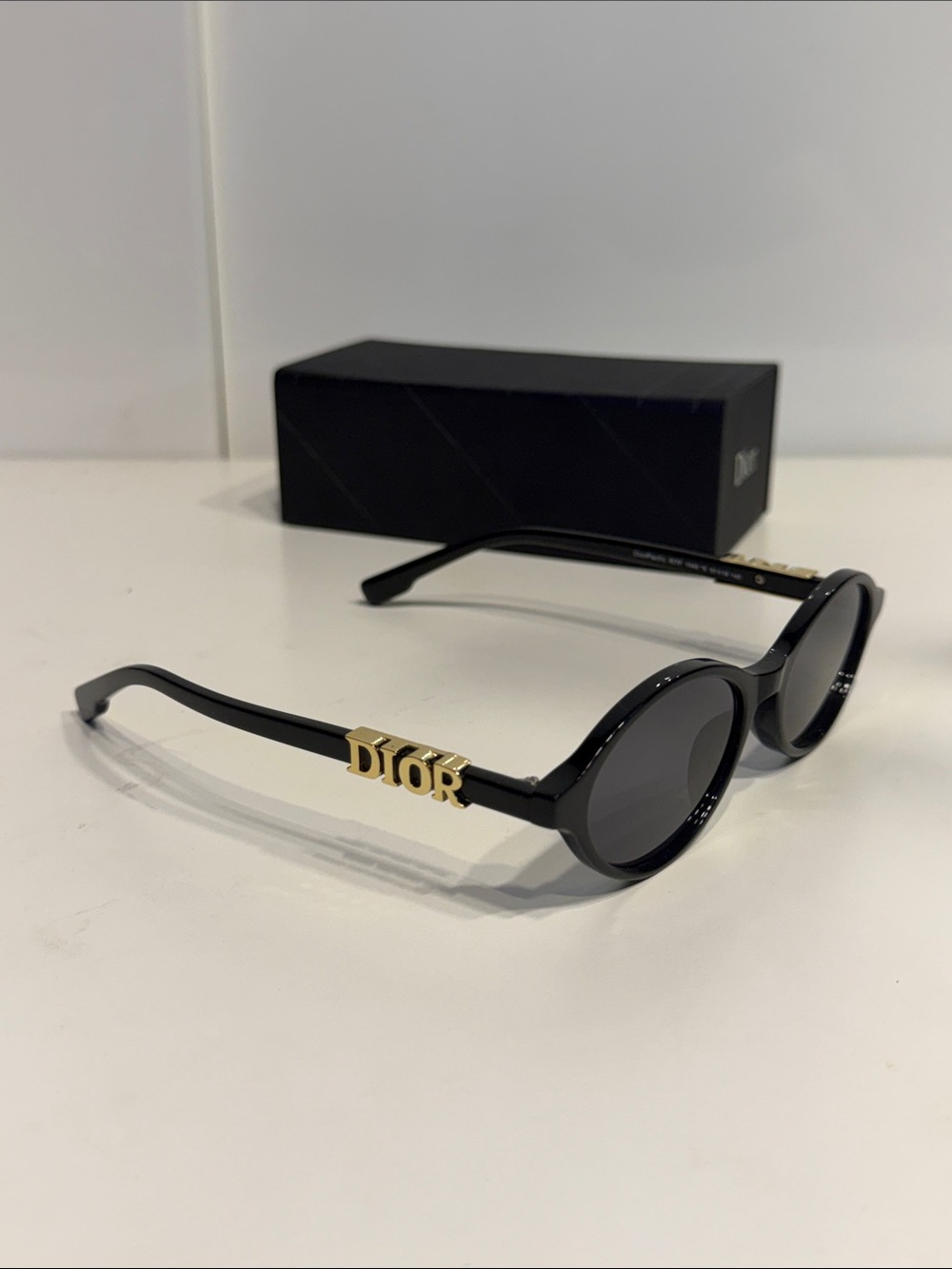 Gently used women’s Dior Black oval Sunglasses with Gold Logo